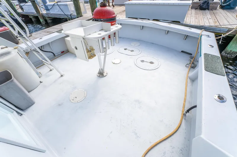 Slide: The Image of 1983 Resmondo 38 boat deck with fishing setup and dockside view. - 11