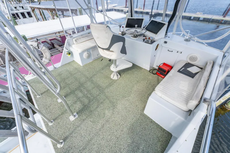 Slide: The Image of Helm of 1983 Resmondo 38 boat with modern navigation equipment and seating. - 16