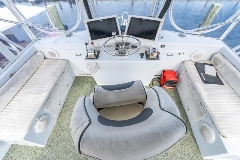 Slide: The Image of Helm of 1983 Resmondo 38 boat with dual screens and cushioned seating. - 18