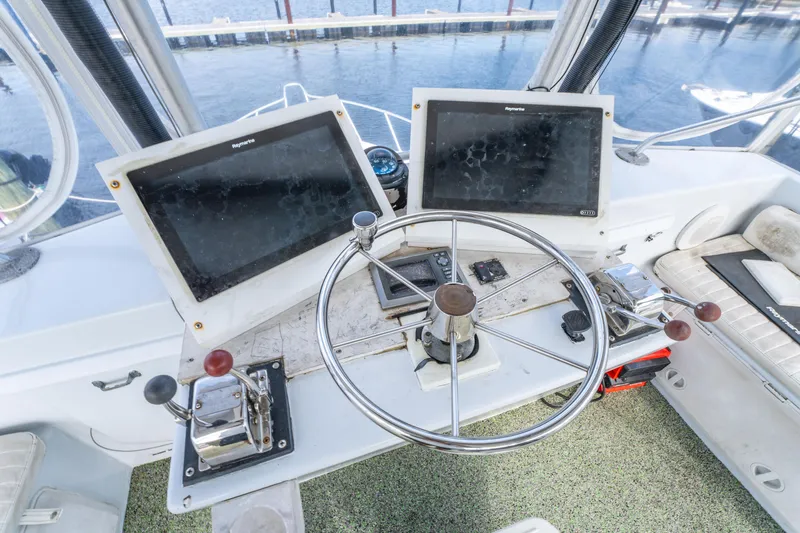 Slide: The Image of Helm of 1983 Resmondo 38 boat with dual screens and steering wheel. - 19