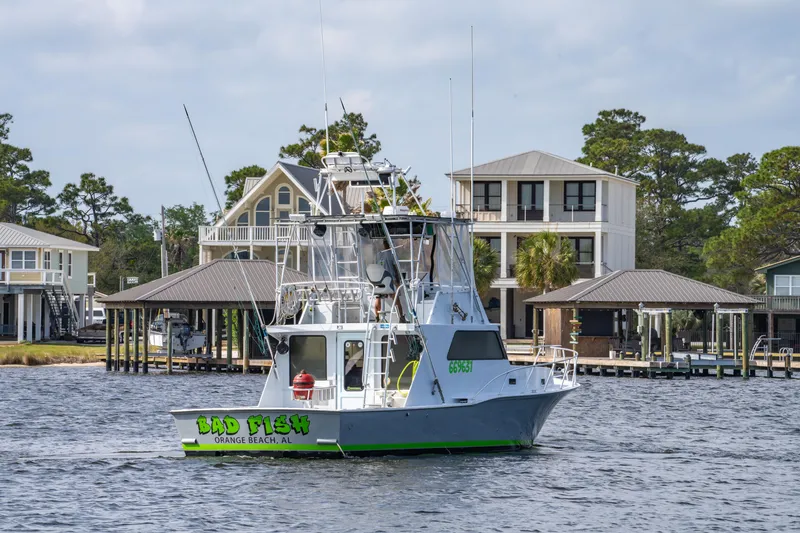Slide: The Image of 1983 Resmondo 38 boat cruising near waterfront homes, Orange Beach, Alabama. - 2