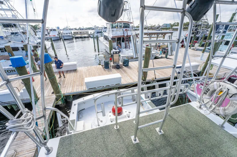 Slide: The Image of Docked Resmondo 38 boat from 1983, surrounded by marina and other vessels. - 21