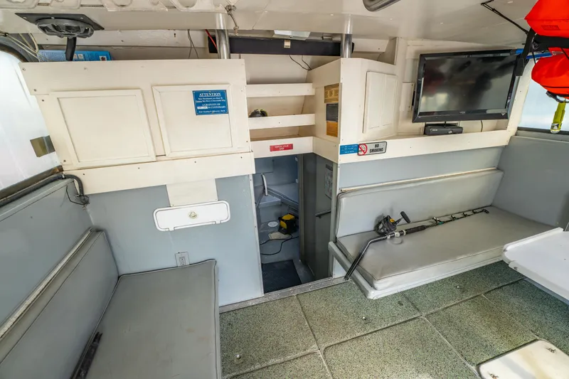 Slide: The Image of Interior of 1983 Resmondo 38 boat with seating, TV, and storage compartments. - 24