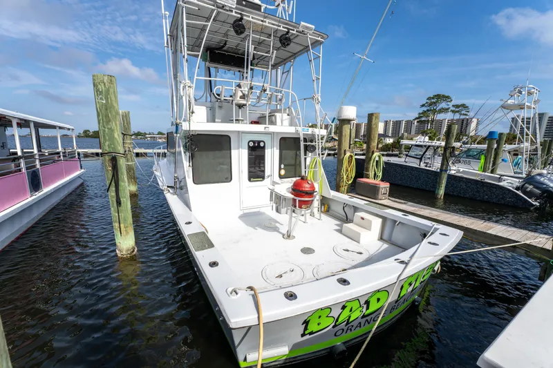 Slide: The Image of 1983 Resmondo 38 boat docked at marina with clear blue sky. - 34