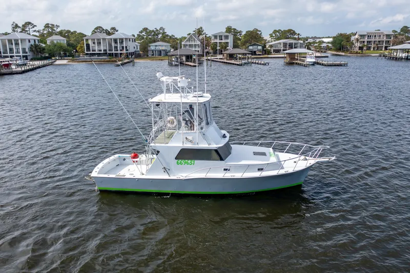 Slide: The Image of 1983 Resmondo 38 boat on calm water near waterfront homes. - 40