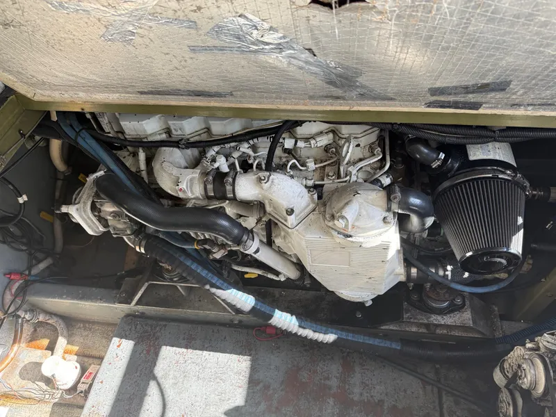 Slide: The Image of Engine compartment of a 1983 Resmondo 38, showcasing mechanical components and wiring. - 44