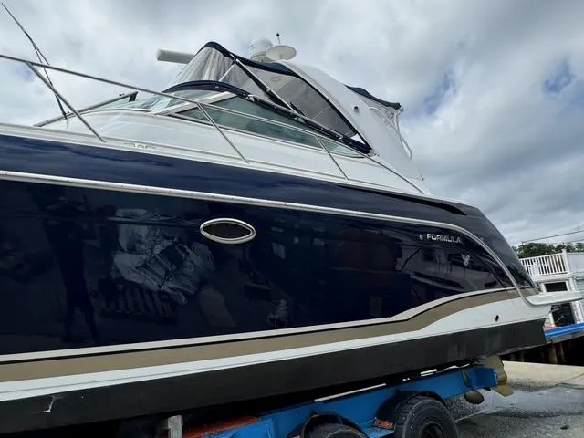 Slide: The Image of 2013 Formula 40pc yacht on trailer, dark blue hull, dockside view. - 10