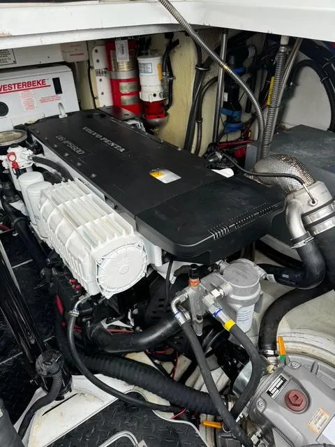 Slide: The Image of Engine compartment of a 2013 Formula 40pc boat, featuring a well-maintained motor and components. - 17
