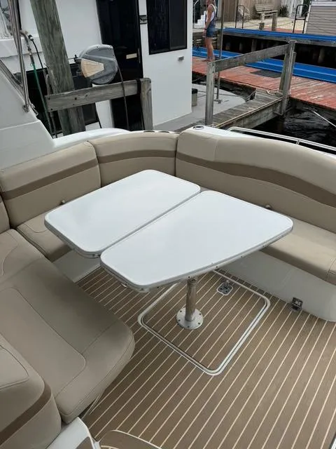 Slide: The Image of 2013 Formula 40pc boat interior with beige seating and dual white tables. - 21