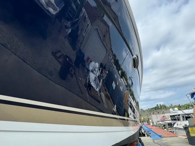 Slide: The Image of 2013 Formula 40pc boat with reflective hull in a marina setting. - 8