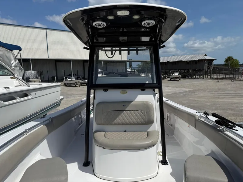 Slide: The Image of 2021 Sportsman Open 282 boat with seating, docked under clear skies. - 10