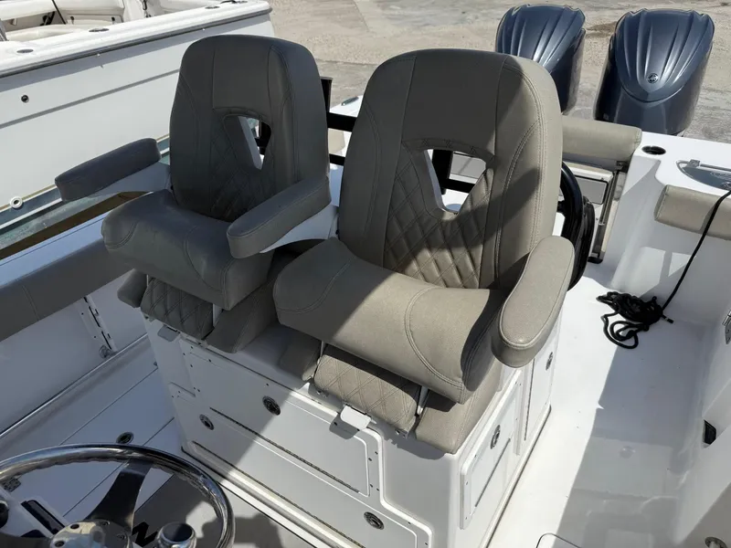 Slide: The Image of 2021 Sportsman Open 282 boat seats with armrests and diamond stitching. - 11