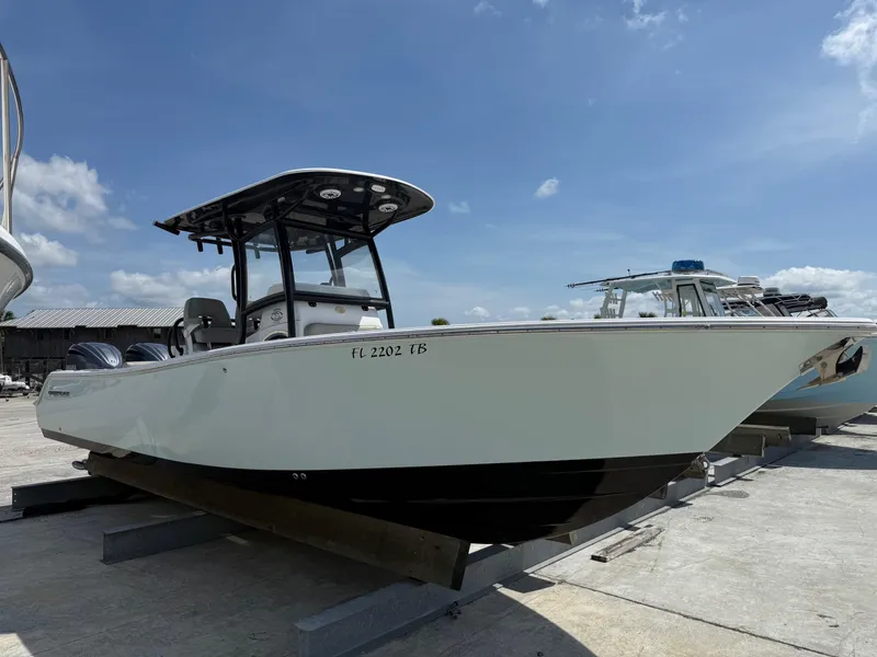 Slide: The Image of 2021 Sportsman Open 282 boat on display under a clear blue sky. - 3