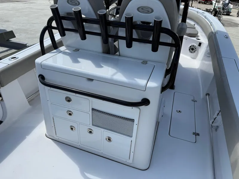 Slide: The Image of 2021 Sportsman Open 282 boat interior with storage compartments and rod holders. - 7