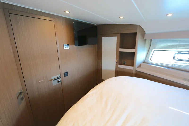 Slide: The Image of 2019 Beneteau Gran Turismo 50 cabin interior with wood finish and window view. - 12