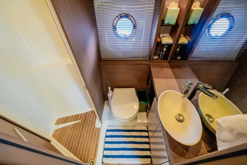 Slide: The Image of 2019 Beneteau Gran Turismo 50 bathroom with modern fixtures and nautical decor. - 13