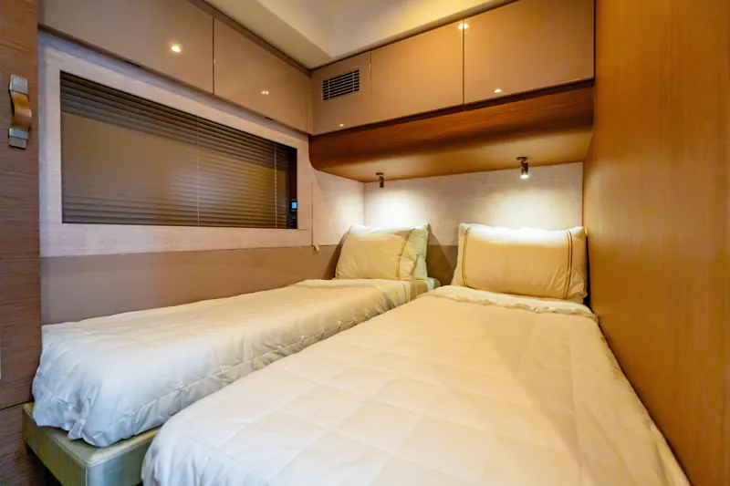 Slide: The Image of Twin cabin interior of 2019 Beneteau Gran Turismo 50 yacht, featuring modern design and cozy bedding. - 14