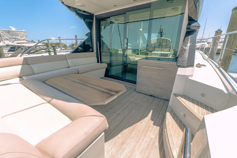 Slide: The Image of 2019 Beneteau Gran Turismo 50 yacht with spacious outdoor seating and glass doors. - 18