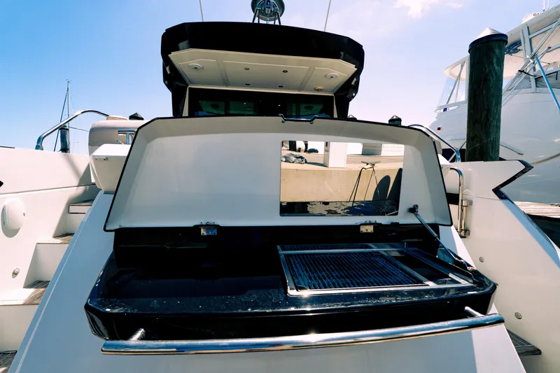 Slide: The Image of 2019 Beneteau Gran Turismo 50 yacht with open rear deck and grill. - 19