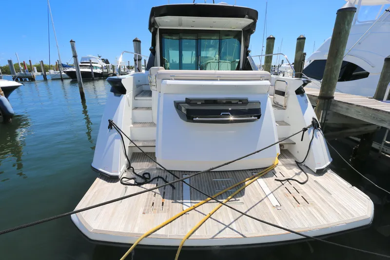 Slide: The Image of 2019 Beneteau Gran Turismo 50 yacht docked at marina, rear view. - 21