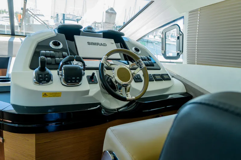 Slide: The Image of 2019 Beneteau Gran Turismo 50 helm with advanced navigation controls and steering wheel. - 4