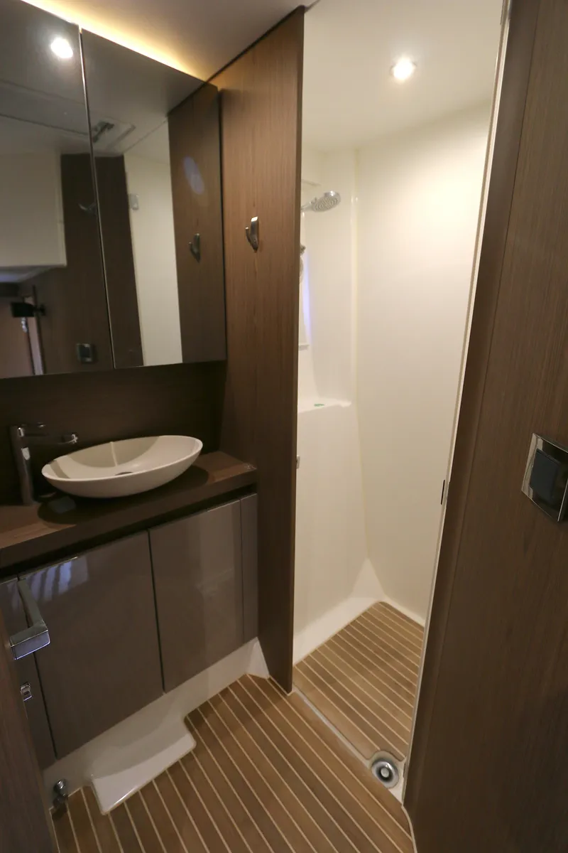 Slide: The Image of 2019 Beneteau Gran Turismo 50 bathroom with modern fixtures and wood accents. - 9