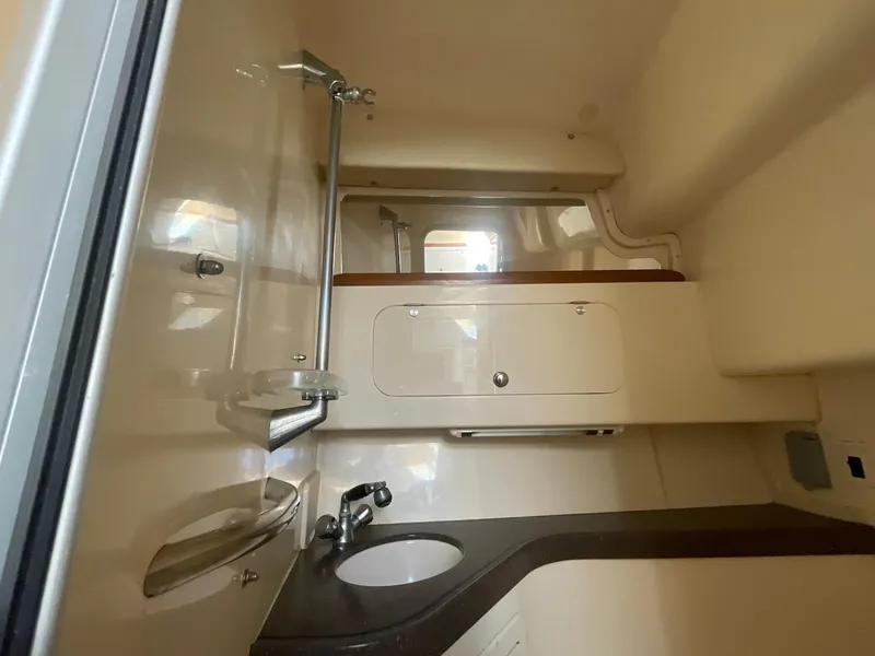 Slide: The Image of 2002 Grady-White Express 330 boat interior with sink and storage cabinets. - 15