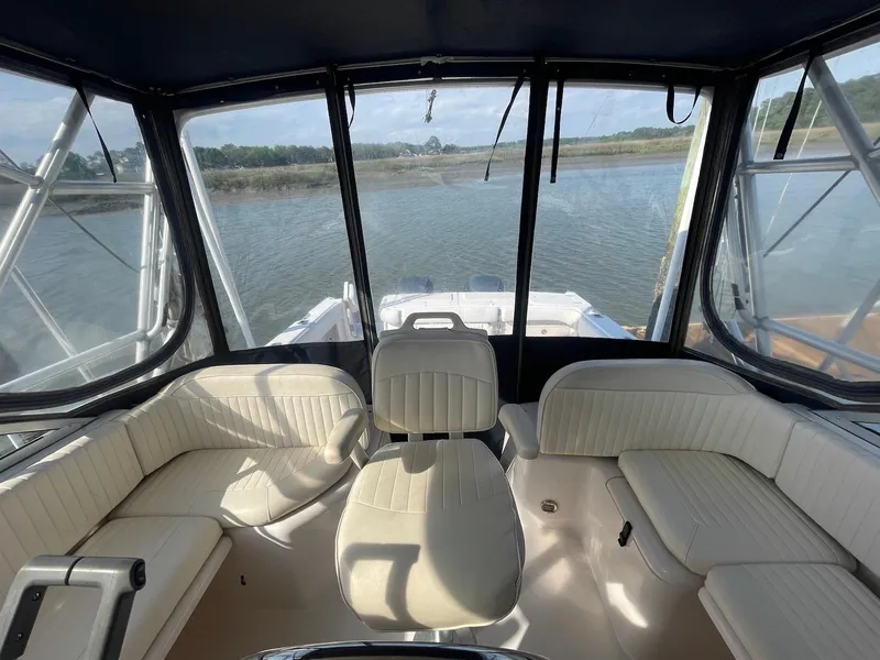 Slide: The Image of 2002 Grady-White Express 330 boat interior with seating, overlooking calm waters. - 3