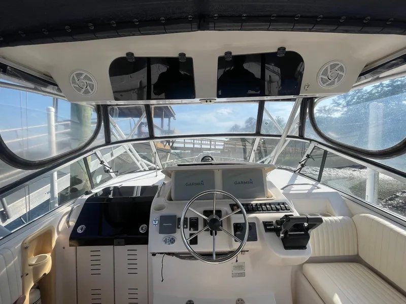 Slide: The Image of 2002 Grady-White Express 330 boat cockpit with steering wheel and navigation equipment. - 4