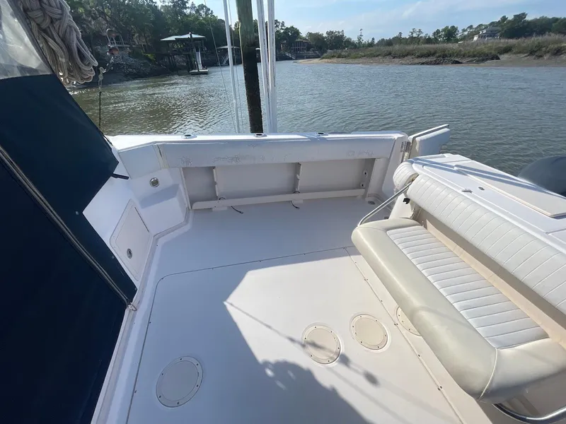 Slide: The Image of 2002 Grady-White Express 330 boat deck with seating, near calm waters. - 8