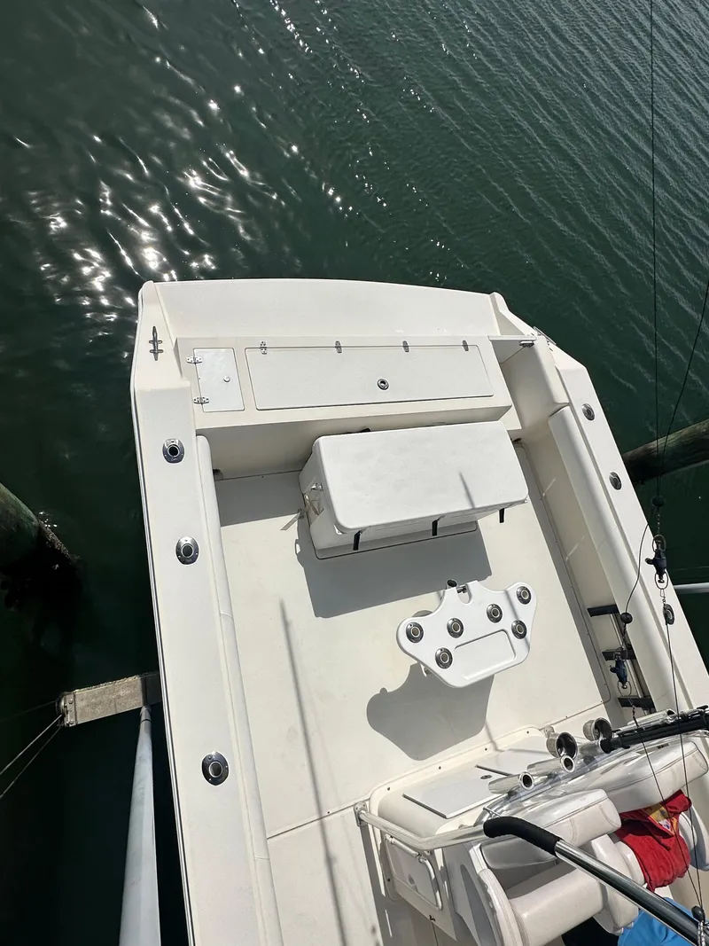 Slide: The Image of 2016 Strike 35 boat docked on calm water, featuring a spacious deck layout. - 11