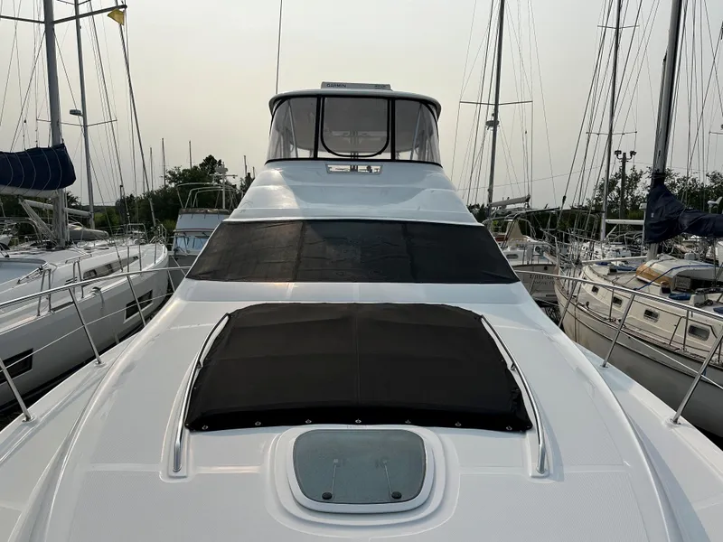 Slide: The Image of 2006 Sea Ray 58 Sedan Bridge yacht docked among sailboats. - 11