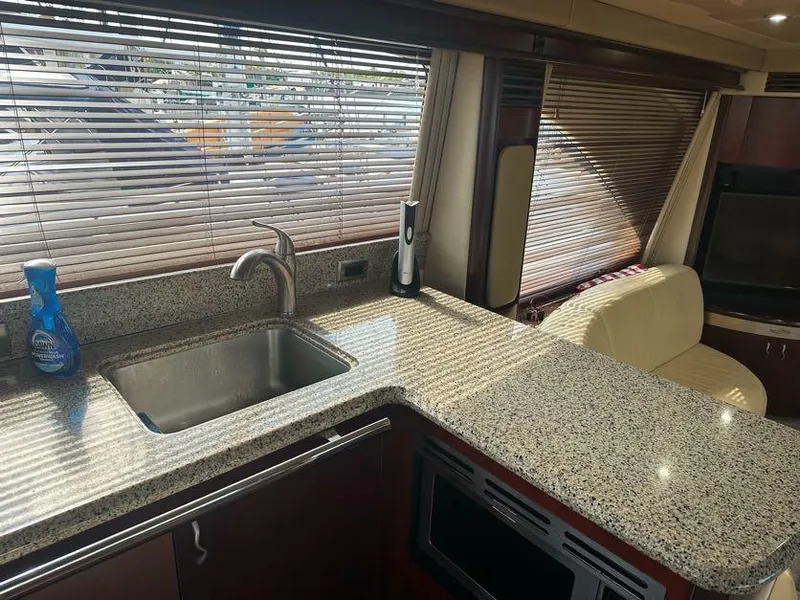 Slide: The Image of Luxurious 2006 Sea Ray 58 Sedan Bridge yacht interior with granite countertops and modern kitchen amenities. - 20