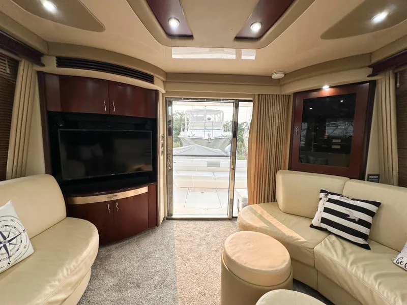 Slide: The Image of Luxurious interior of 2006 Sea Ray 58 Sedan Bridge yacht with plush seating and entertainment system. - 22