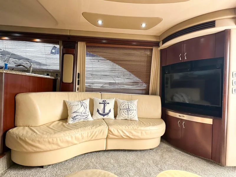 Slide: The Image of Luxurious interior of 2006 Sea Ray 58 Sedan Bridge with leather sofa and nautical decor. - 24
