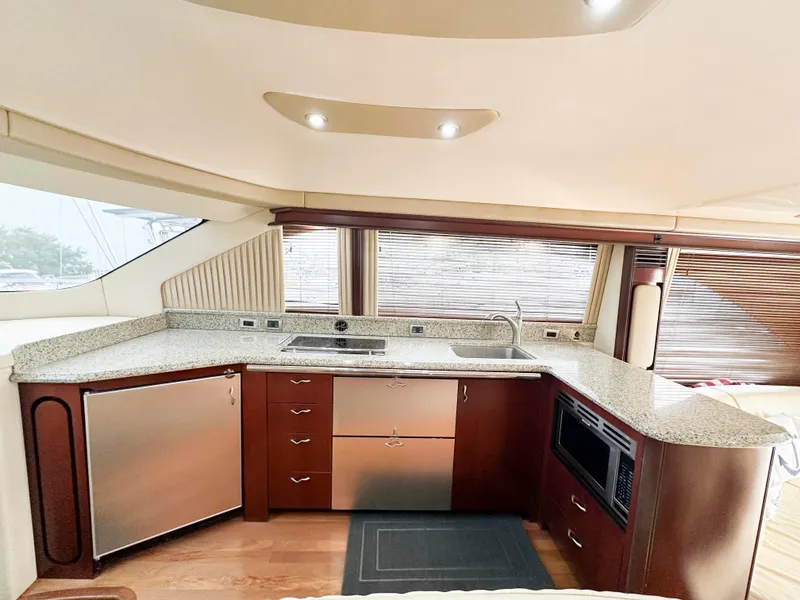 Slide: The Image of Luxurious kitchen interior of 2006 Sea Ray 58 Sedan Bridge yacht with modern appliances. - 25