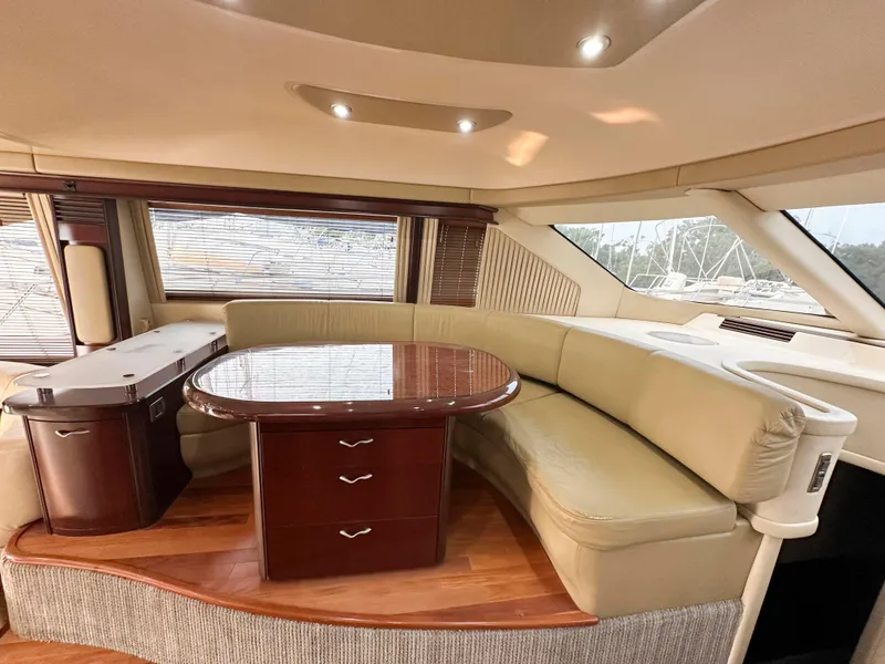 Slide: The Image of Luxurious interior of 2006 Sea Ray 58 Sedan Bridge yacht with elegant seating and table. - 27
