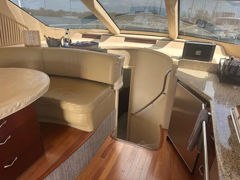 Slide: The Image of Interior of 2006 Sea Ray 58 Sedan Bridge yacht with leather seating and wooden flooring. - 28