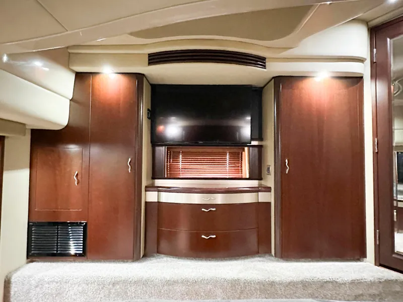 Slide: The Image of Luxurious interior of 2006 Sea Ray 58 Sedan Bridge with wood cabinets and TV. - 32