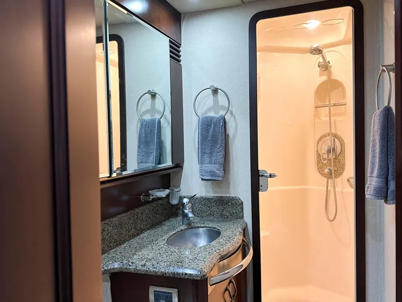 Slide: The Image of Luxurious bathroom in 2006 Sea Ray 58 Sedan Bridge yacht with granite countertop and shower. - 33