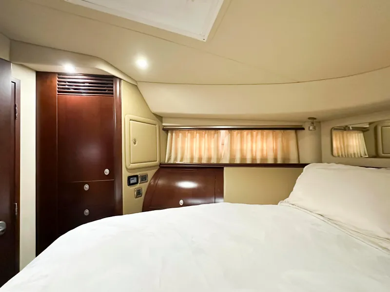 Slide: The Image of Interior cabin of 2006 Sea Ray 58 Sedan Bridge yacht with wood accents and cozy bedding. - 36