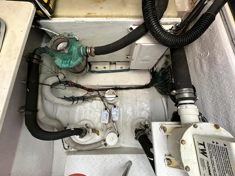 Slide: The Image of Engine compartment of a 2006 Sea Ray 58 Sedan Bridge with visible hoses and components. - 48