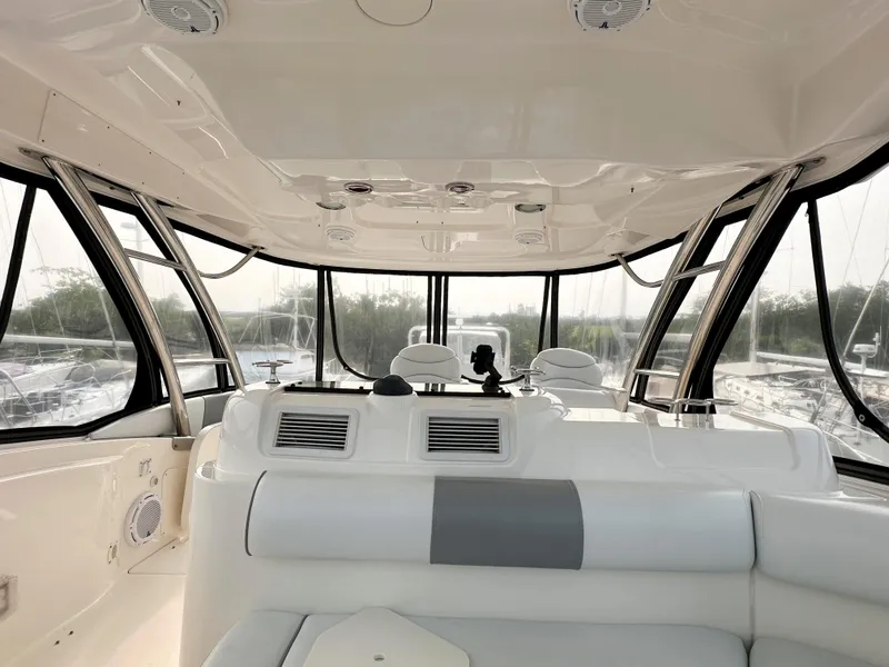 Slide: The Image of 2006 Sea Ray 58 Sedan Bridge interior with panoramic windows and plush seating. - 8