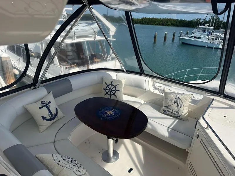 Slide: The Image of Luxurious 2006 Sea Ray 58 Sedan Bridge yacht interior with nautical-themed cushions. - 9