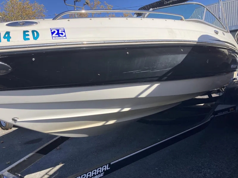 Slide: The Image of 2008 Chaparral 210 SSi boat on trailer, black and white hull, outdoor setting. - 1