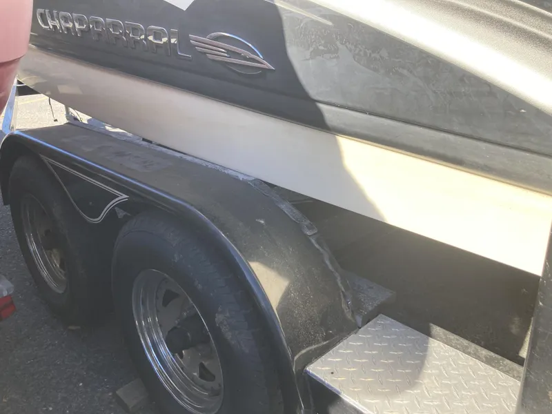 Slide: The Image of 2008 Chaparral 210 SSi boat on trailer, close-up view of side and wheels. - 2