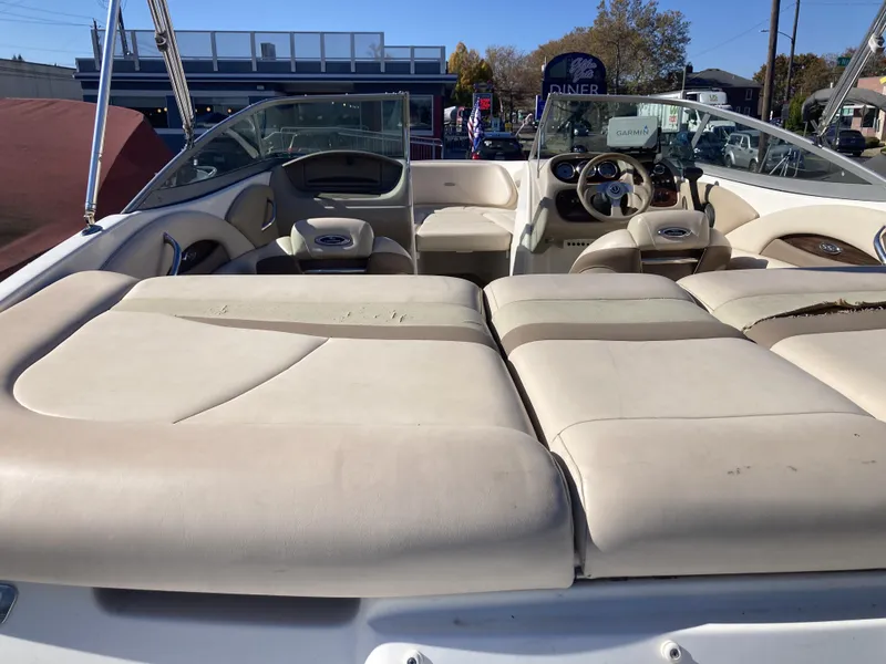 Slide: The Image of 2008 Chaparral 210 SSi boat interior with beige seating and steering wheel. - 6