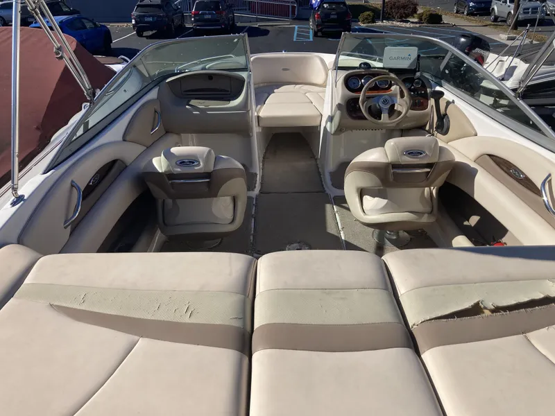 Slide: The Image of 2008 Chaparral 210 SSi boat interior with beige seating and steering console. - 7