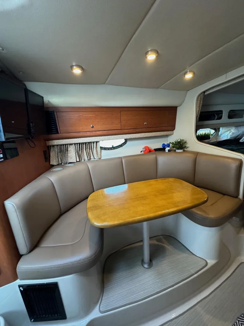 Slide: The Image of 2003 Chaparral Signature 280 interior with cozy seating and wooden table. - 11