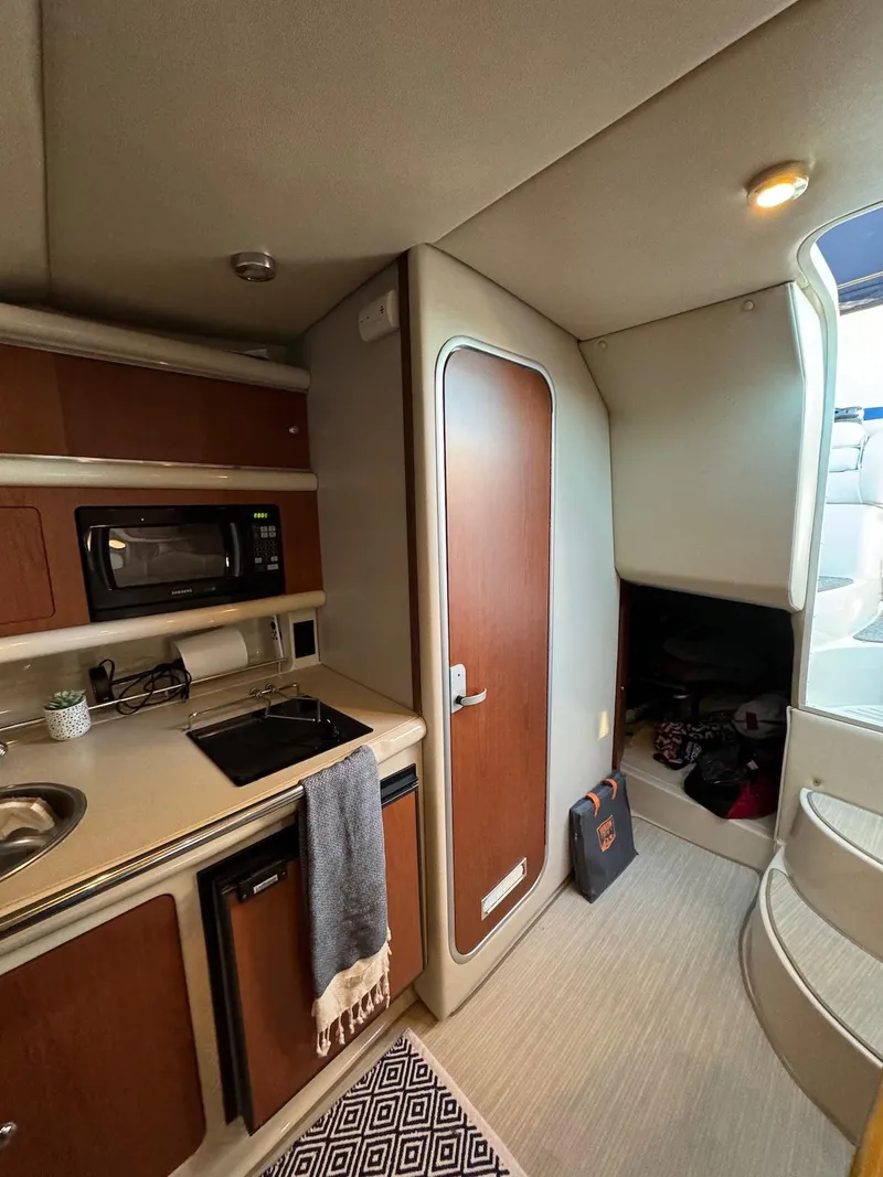 Slide: The Image of Interior of 2003 Chaparral Signature 280 boat with kitchenette and stairs. - 15